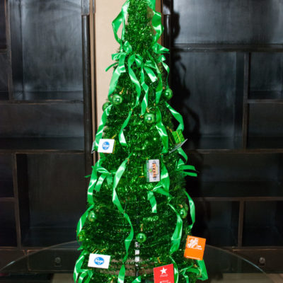 green giving tree on a table surrounded by gift cards on the table underneath it